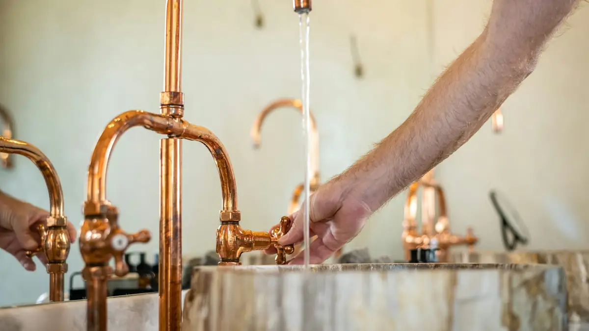 Water running from copper faucets